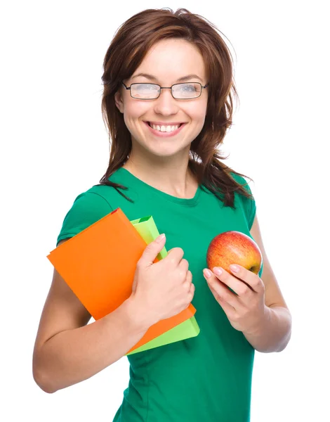 Joven estudiante chica está sosteniendo libro y manzana — Foto de Stock