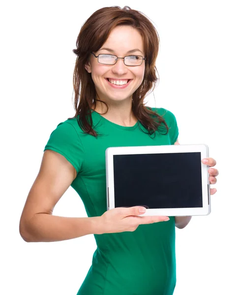 Young cheerful woman is showing blank tablet — Stock Photo, Image