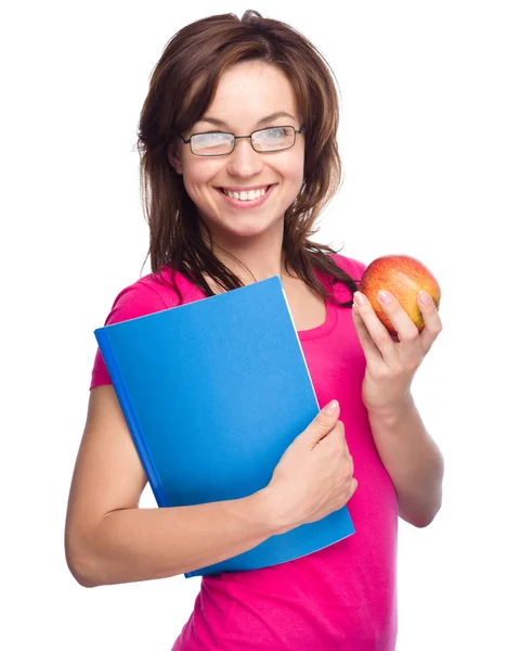 Giovane studentessa è in possesso di libro e mela — Foto Stock