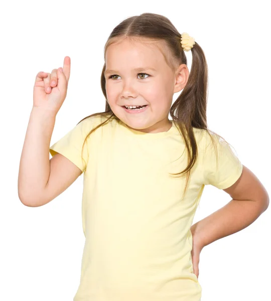 Söt liten flicka pekar uppåt — Stockfoto