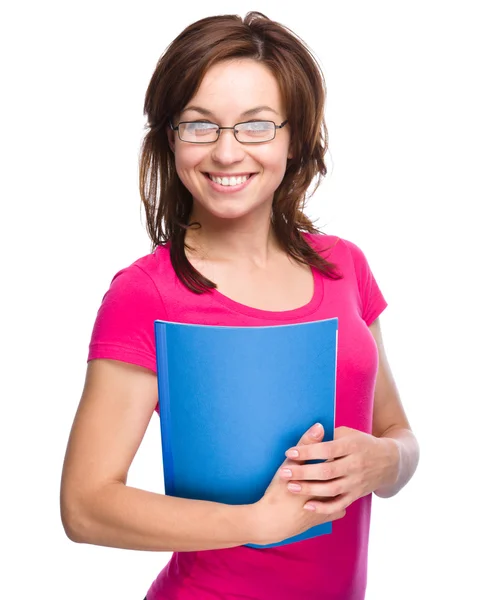 Young skinny student girl is holding exercise book — Stock Photo, Image