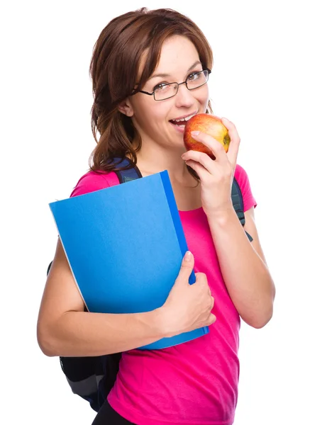 Joven estudiante chica está sosteniendo libro y manzana — Foto de Stock