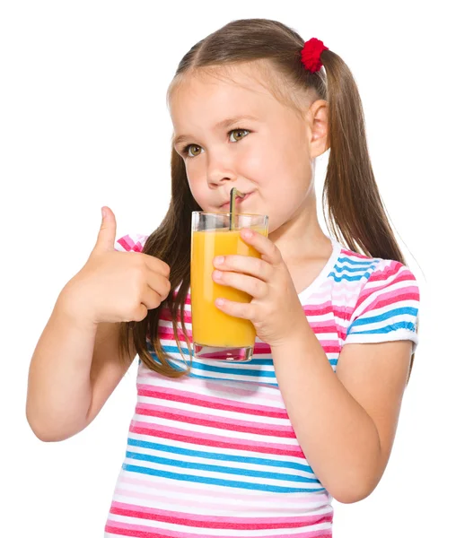 Little girl is drinking orange juice — Stock Photo, Image