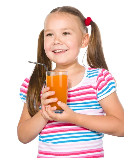 Little girl is drinking carrot juice — Stock Photo, Image