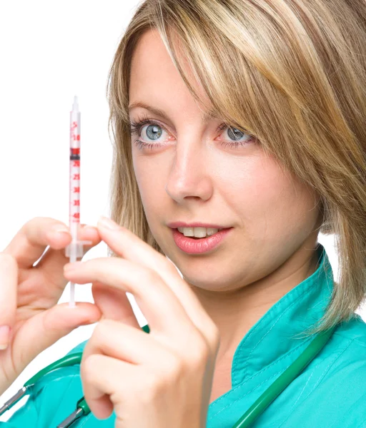 Young nurse is preparing syringe for injection — Stock Photo, Image