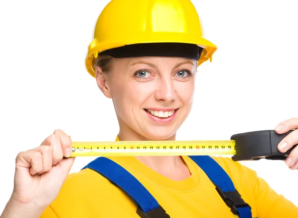 Young construction worker with tape measure — Stock Photo, Image