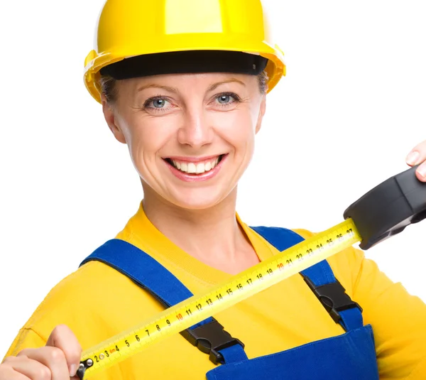 Young construction worker with tape measure — Stock Photo, Image