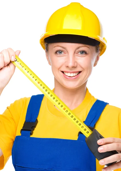 Young construction worker with tape measure — Stock Photo, Image