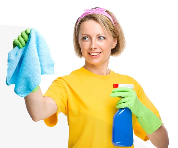 Young woman is cleaning glass using rag — Stock Photo, Image