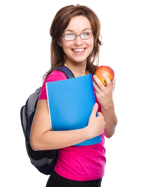 Joven estudiante chica está sosteniendo libro y manzana — Foto de Stock