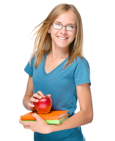 年轻的学生女孩拿着书和苹果 — 图库照片