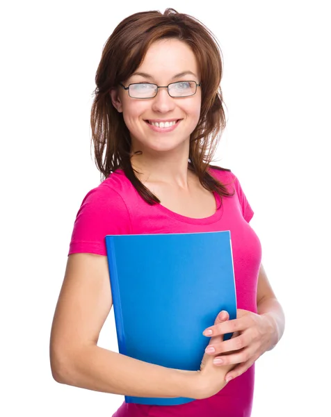 Young skinny student girl is holding exercise book — Stock Photo, Image