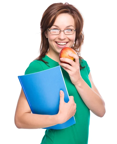 若い学生の女の子は、本とリンゴを保持しています。 — ストック写真
