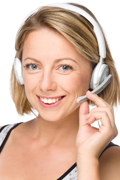 Lovely young woman is talking to customers — Stock Photo, Image