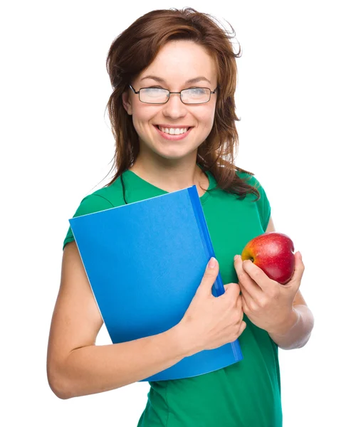 Jeune fille étudiante tient livre et pomme — Photo