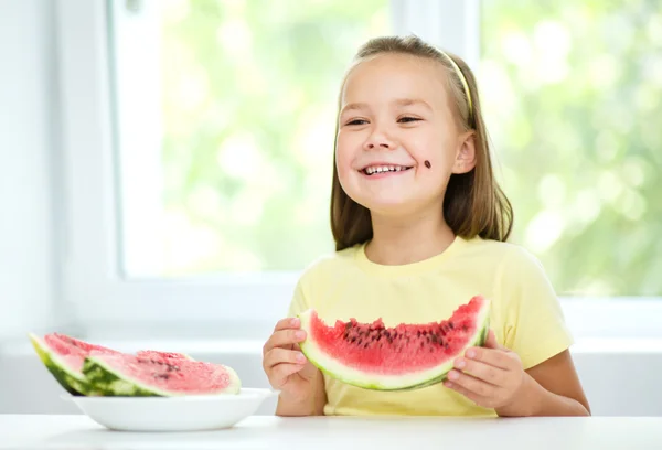 Cute little girl is eating watermelon — Stock Photo, Image