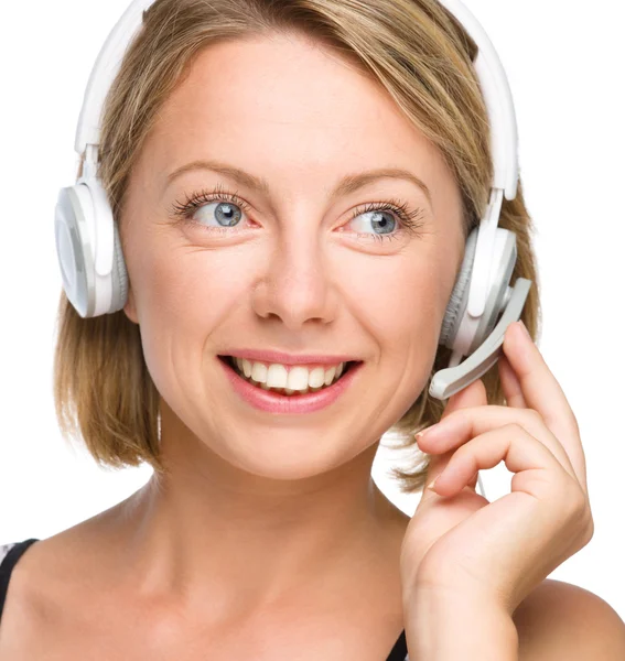 Lovely young woman is talking to customers — Stock Photo, Image