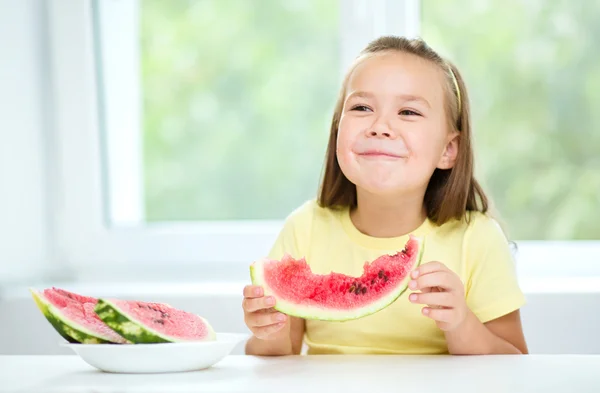 Cute little girl is eating watermelon — Stock Photo, Image