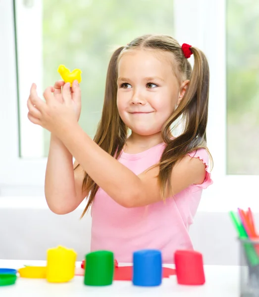 Kleines Mädchen spielt mit Knetmasse — Stockfoto