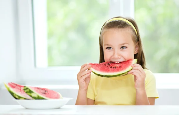 Cute little girl is eating watermelon — Stock Photo, Image