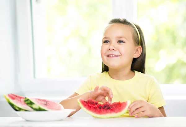 Cute little girl is eating watermelon — Stock Photo, Image