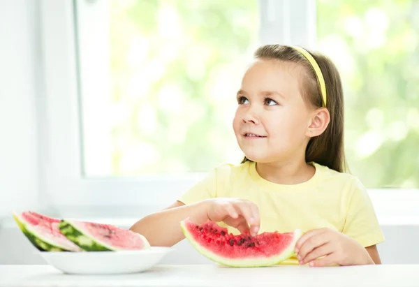 Cute little girl is eating watermelon — Stock Photo, Image