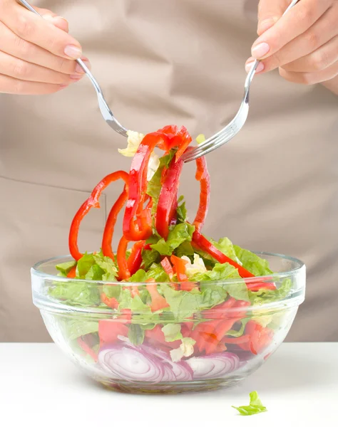 Cook is mixing salad Royalty Free Stock Images