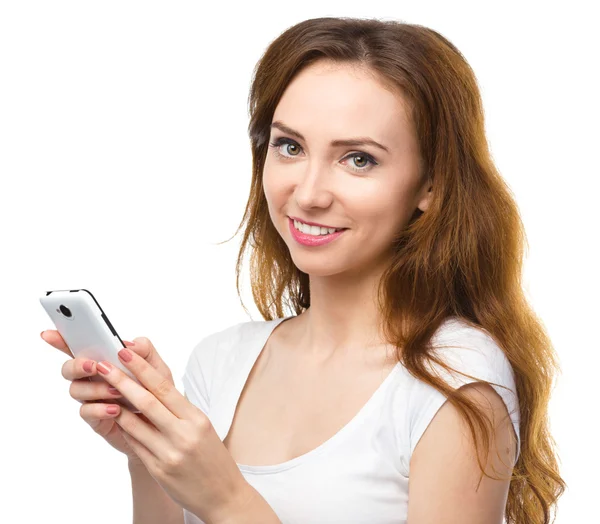 Young woman is typing sms message on her phone — Stock Photo, Image