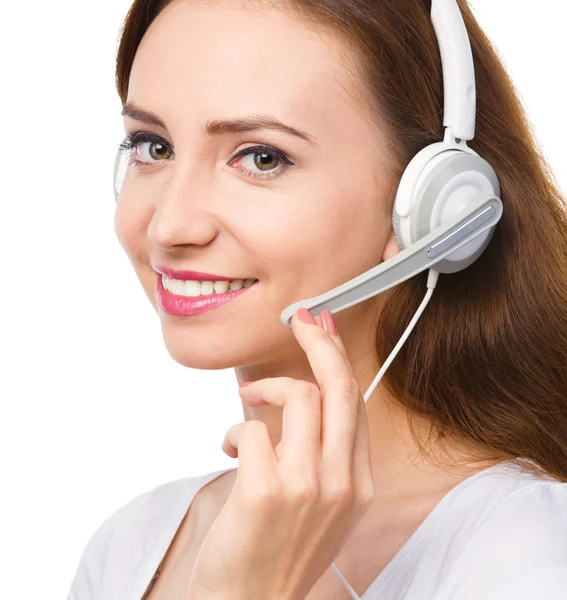 Lovely young woman is talking to customers — Stock Photo, Image