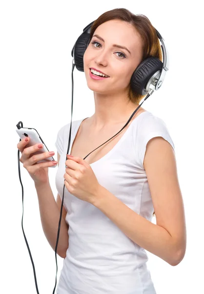 Young woman enjoying music using headphones — Stock Photo, Image