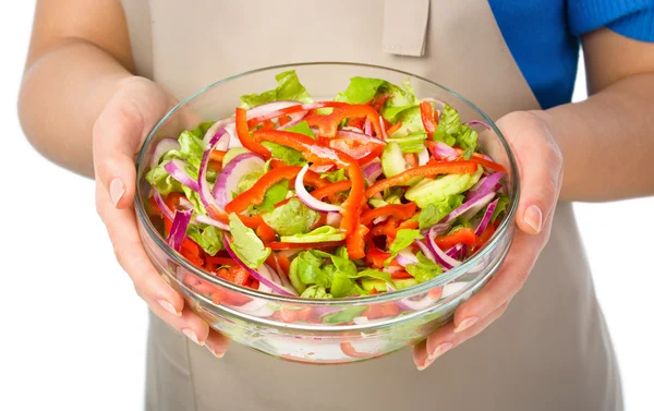 Cook is holding a big bowl with fresh salad — Stock Photo, Image