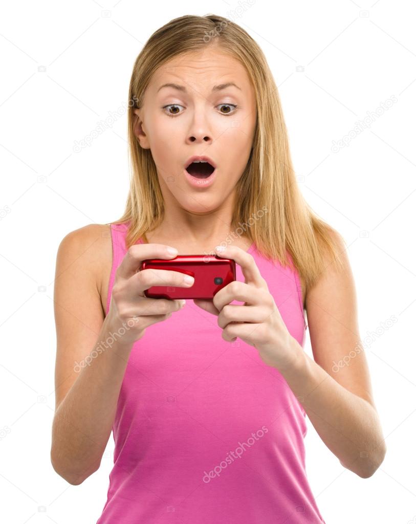 Young teen girl is reading sms message