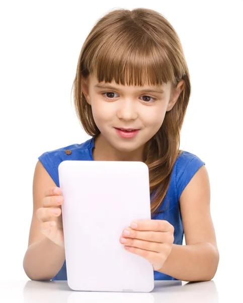 Young cheerful girl is using tablet — Stock Photo, Image