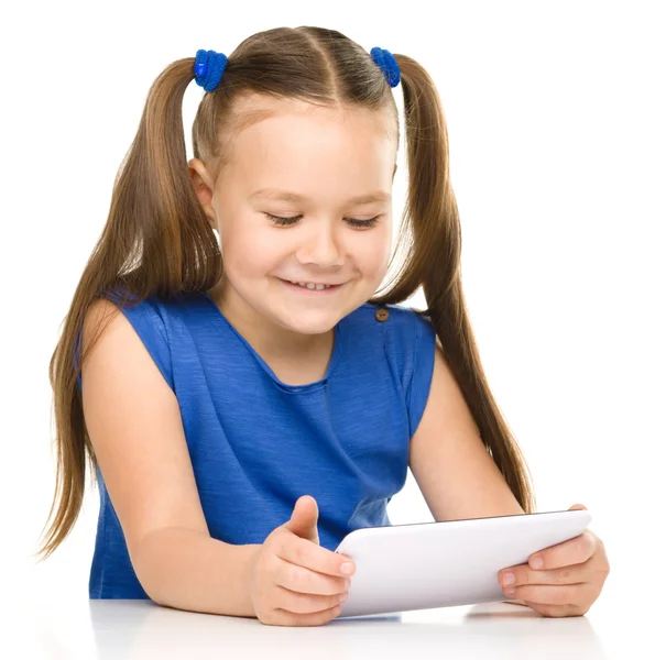 Young cheerful girl is using tablet — Stock Photo, Image