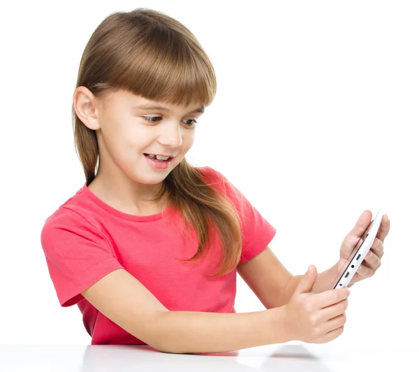 Young cheerful girl is using tablet — Stock Photo, Image