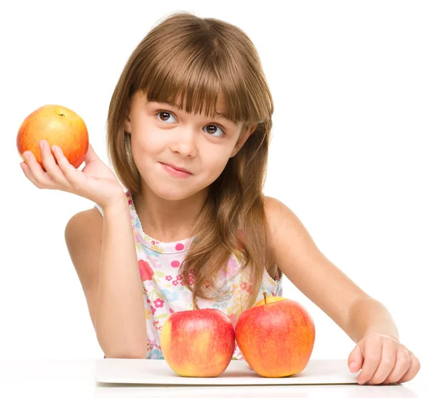 Little girl with red apples — Stock Photo, Image