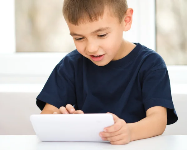 Niño joven está usando tableta —  Fotos de Stock