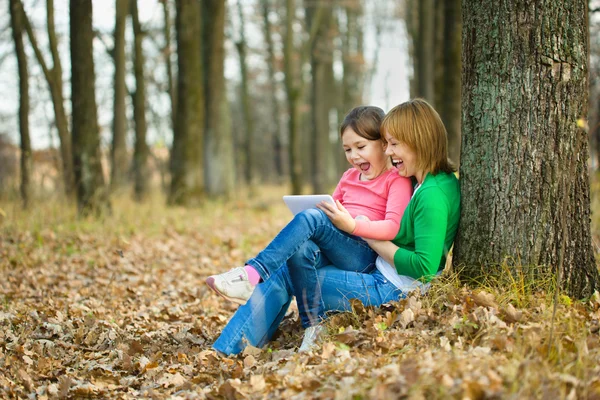 Madre y su hija están jugando con la tableta — Foto de Stock