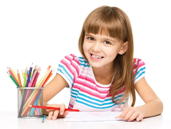 Little girl is drawing using pencils Royalty Free Stock Photos