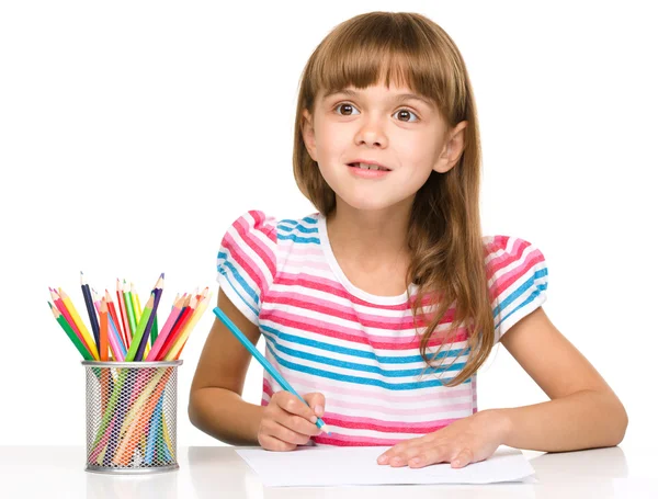 Little girl is drawing using pencils Stock Photo