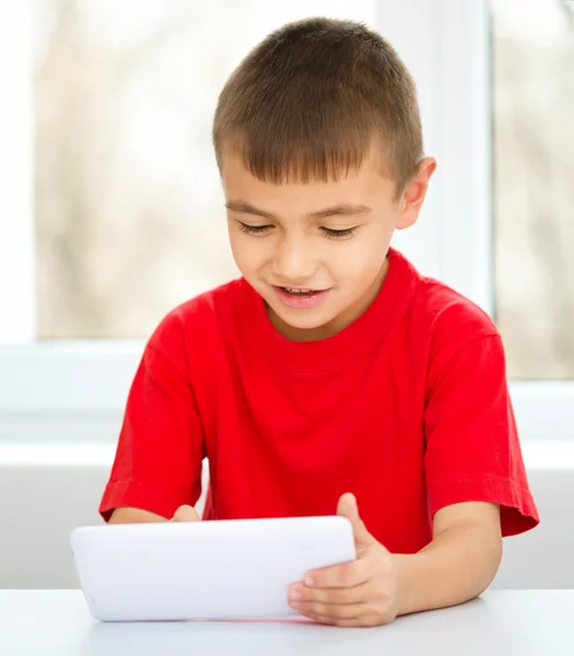 Niño joven está usando tableta —  Fotos de Stock