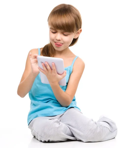 Young girl is using tablet — Stock Photo, Image