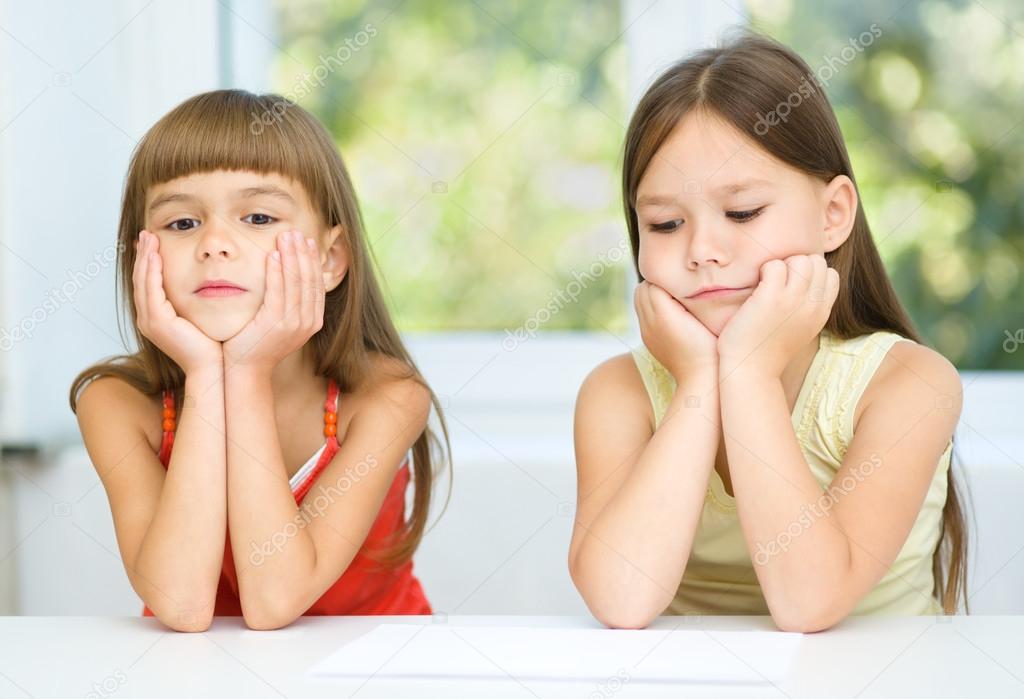Portrait of two sad little girls
