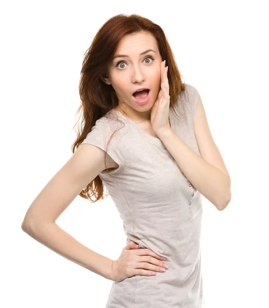 Woman is holding her face in astonishment — Stock Photo, Image