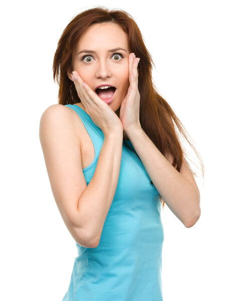 Woman is holding her face in astonishment