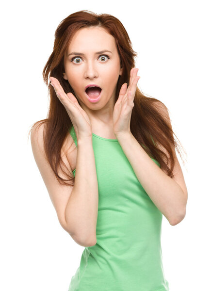 Woman is holding her face in astonishment
