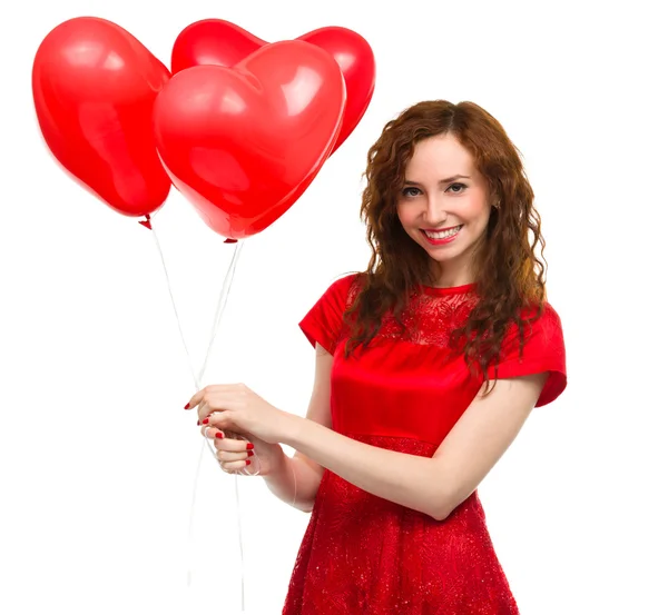 Junge Frau mit herzförmigen Luftballons — Stockfoto