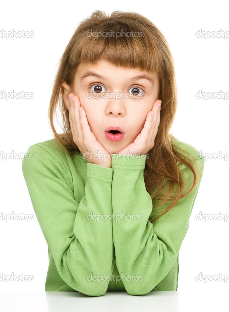 Little girl is holding her face in astonishment