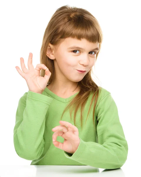 Happy little girl is showing OK sign — Stock Photo, Image