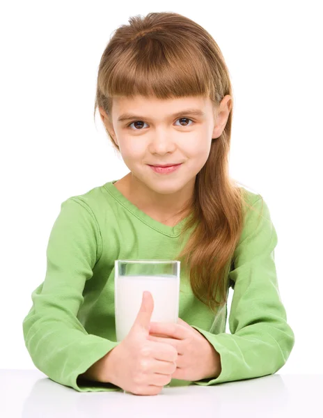 Happy little girl with a glass of milk — Stock Photo, Image